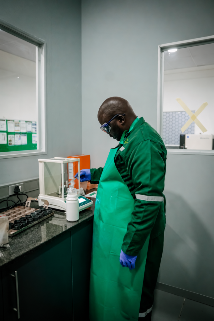 Metallurgist weighing substances in laboratory